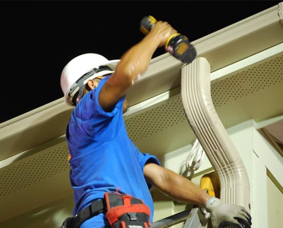 Quality gutter system being installed on a house.